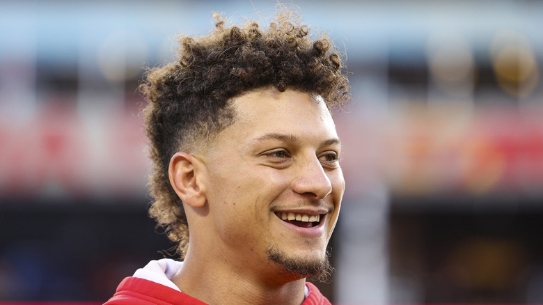 Patrick Mahomes smiling on the field