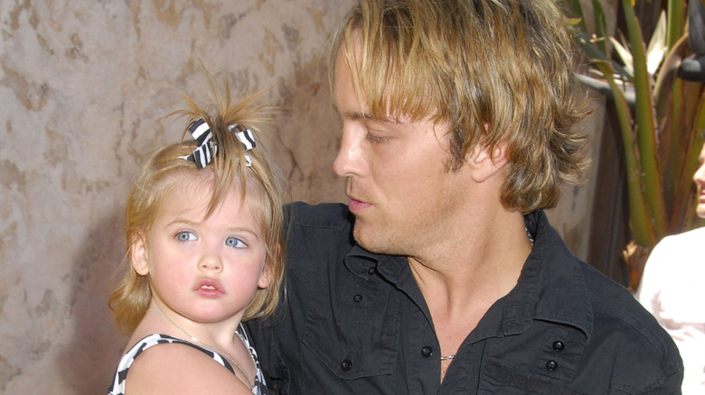 Larry Birkhead holding an infant Dannielynn Birkhead