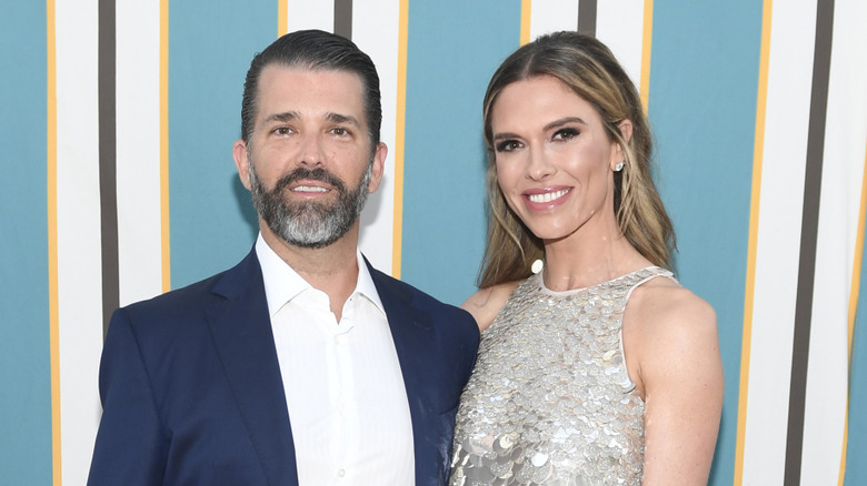 Bettina Anderson in silver dress with Donald Trump Jr.