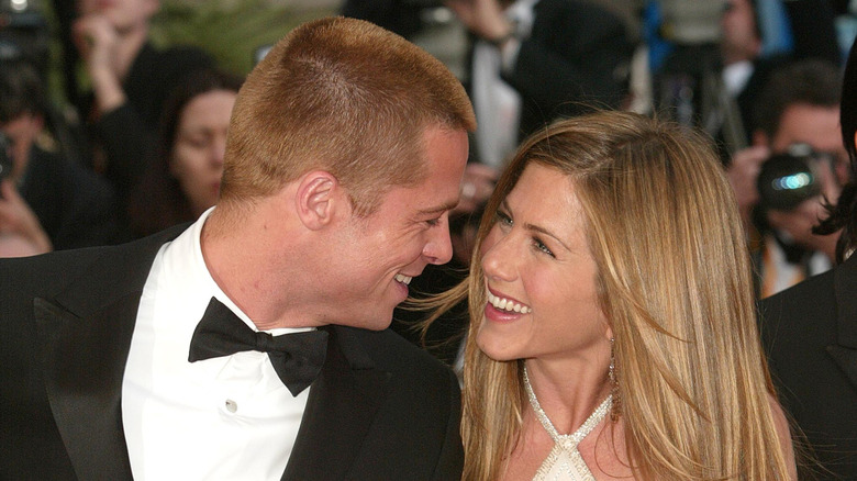 Jennifer Aniston and Brad Pitt smiling on the red carpet