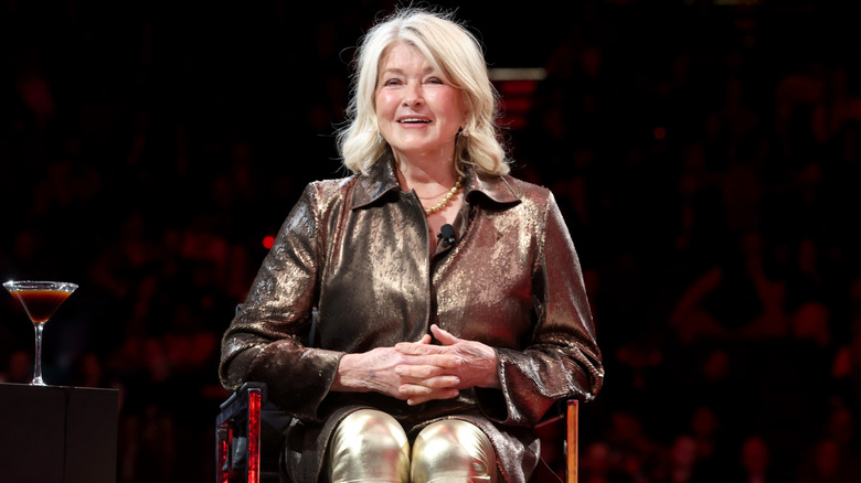 Martha Stewart smiling onstage in an all-gold outfit