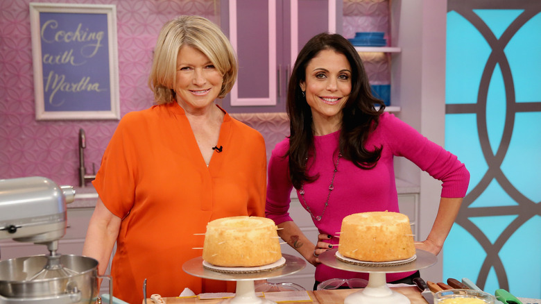 Martha Stewart posing for photos with Bethenny Frankel and a couple of cakes