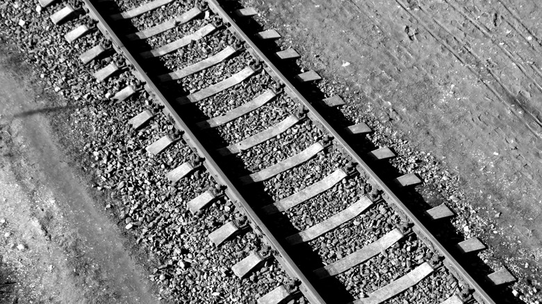 A black and white photograph of train tracks