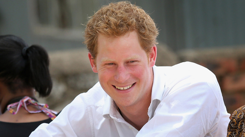 A young Prince Harry smiling