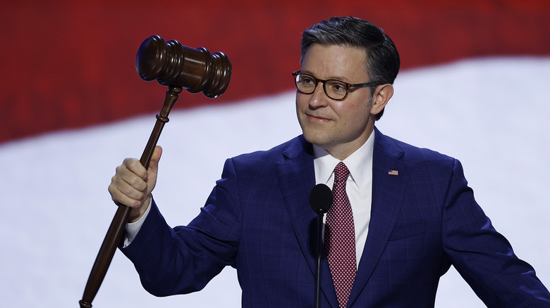 Mike Johnson holding a large gavel