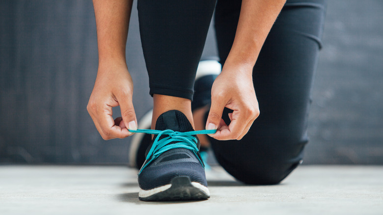 Woman tying her running shoes