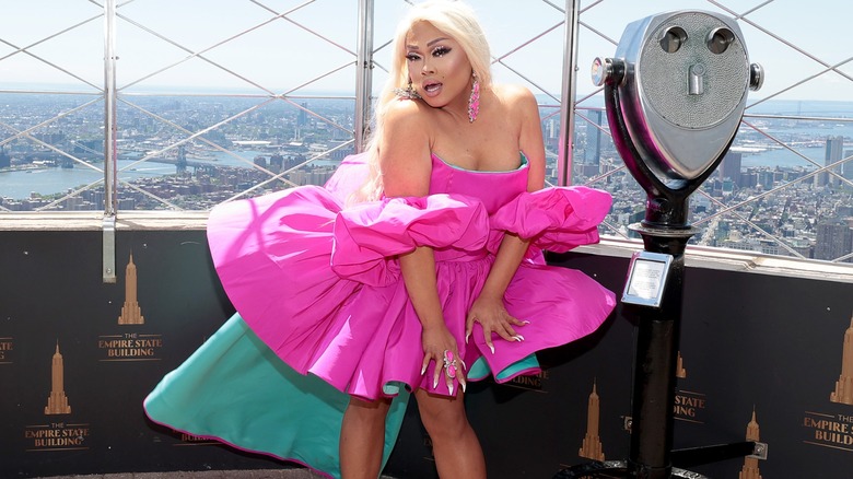 Jiggly Caliente in a puffy pink dress on top of the Empire State Building