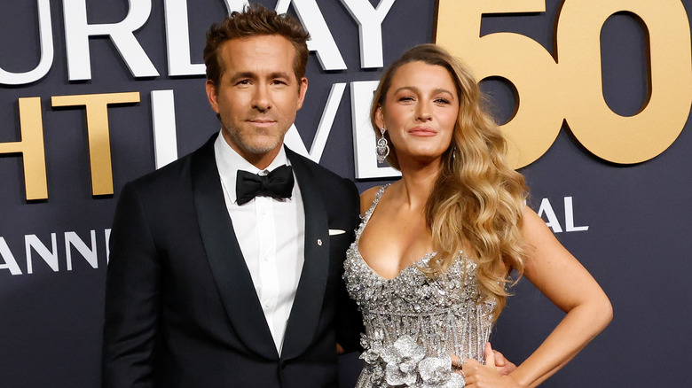 Ryan Reynolds posing for photos with Blake Lively