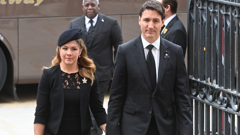 Sophie Gregoire and Justin Trudeau walking into a funeral while holding hands
