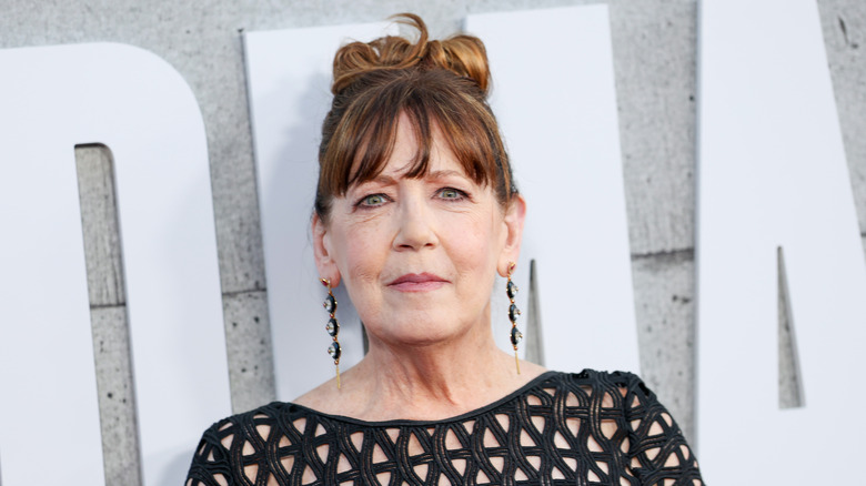 Ann Dowd posing with her hair in an updo in a black dress