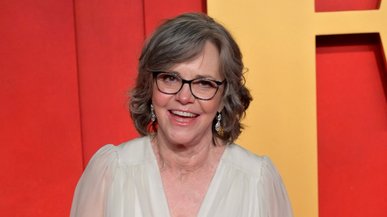Sally Field smiling while posing on the Vanity Fair Oscars party red carpet