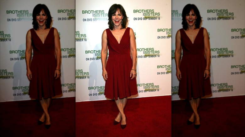Sally Field smiling while posing in a red dress