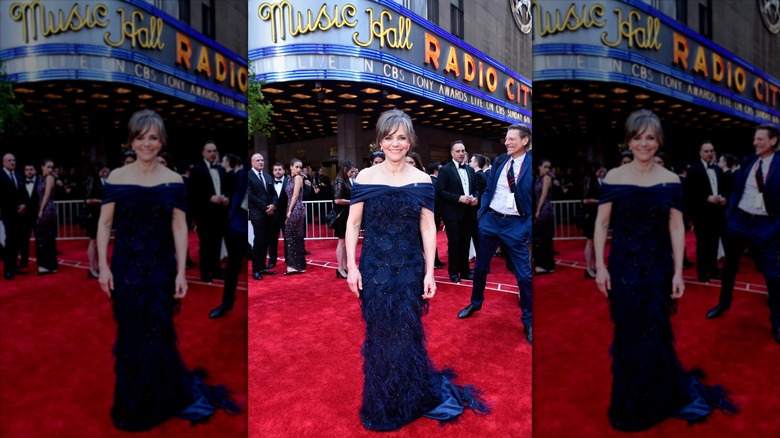 Sally Field smiling for a photo and wearing a navy blue gown at the 2017 Tony Awards