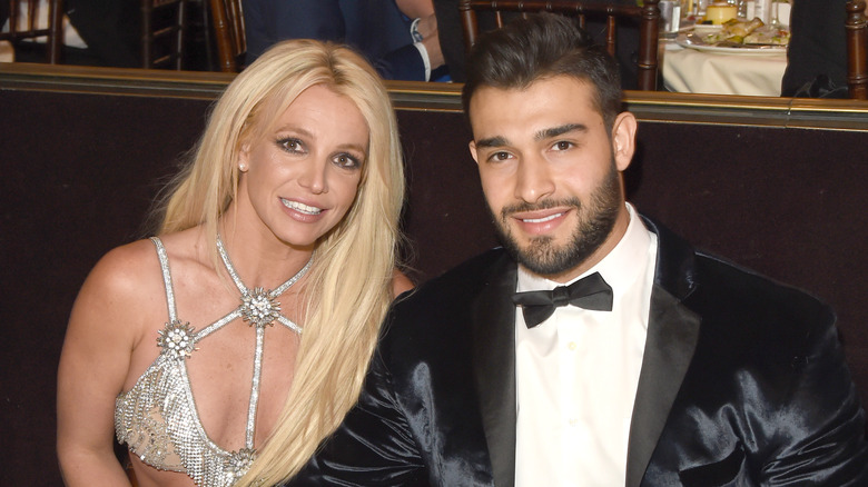 Britney Spears and Sam Asghari posing for photos