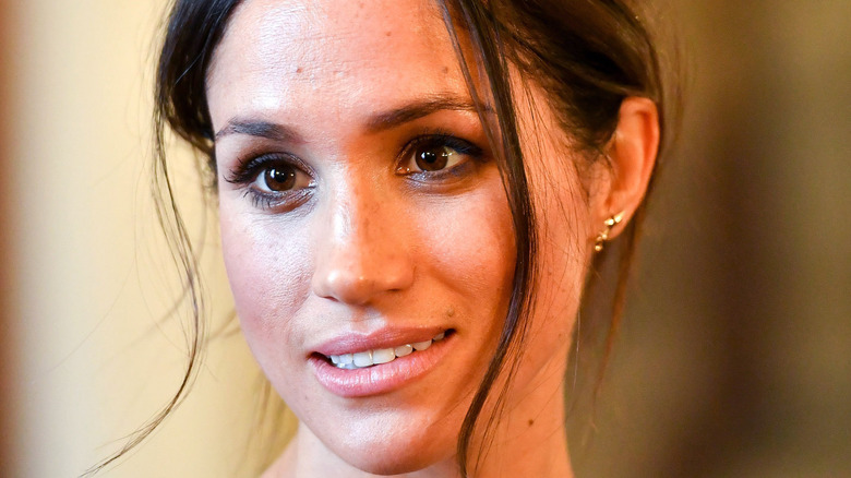 Meghan Markle smiling at an event