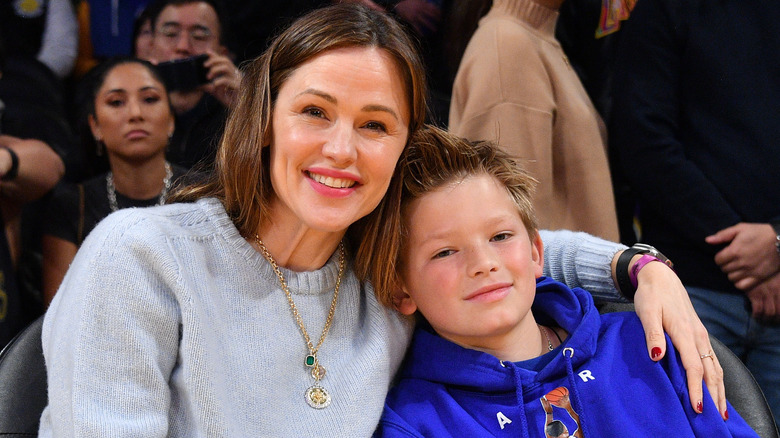 Jennifer Garner with her arm around Sam Affleck at a basketball game