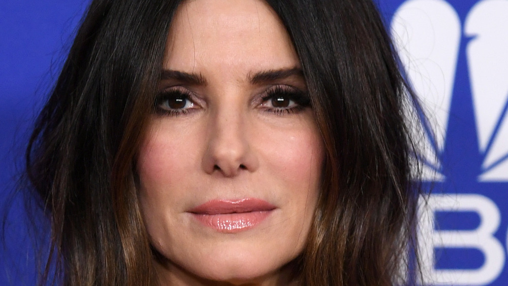 Sandra Bullock with middle part looking serious