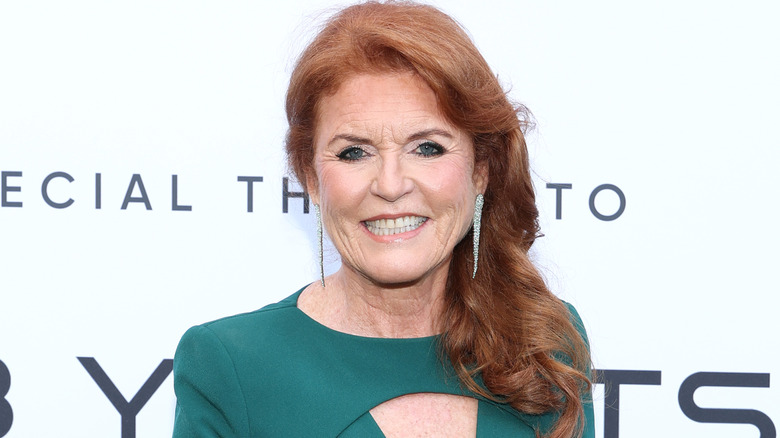 Sarah Ferguson smiling while posing at an event in a green dress
