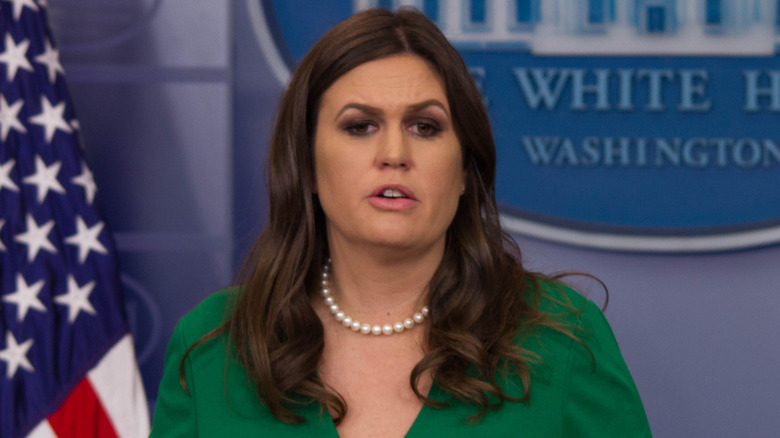 Sarah Huckabee Sanders in green shirt with her mouth open