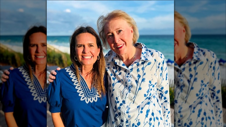 Sarah Huckabee Sanders smiling in a blue shirt next to her mom, Janet Huckabee, who's wearing a very light blue floral shirt.
