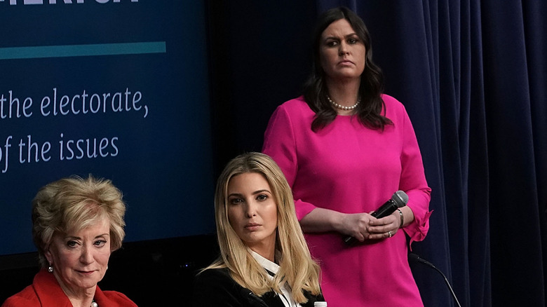 Sarah Huckabee Sanders standing behind Ivanka Trump.