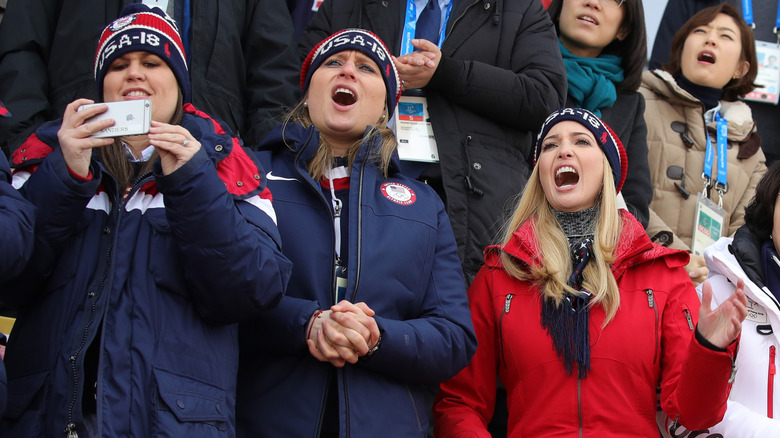 Sarah Huckabee Sanders filming the Winter Olympics with Ivanka Trump cheering next to her