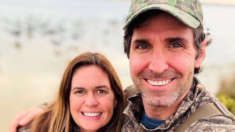 Bryan Chetfield Sanders with his arm on Sarah Huckabee Sanders' right shoulder