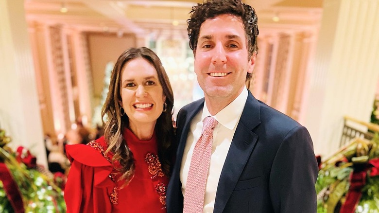 image of Sarah Huckabee Sanders and her husband side by side.