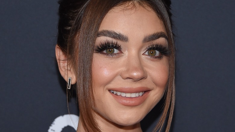 Sarah Hyland smiling for press