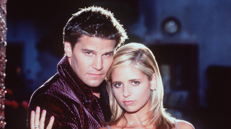 Sarah Michelle Geller and David Boreanaz posing for a promo for Buffy the Vampire Slayer