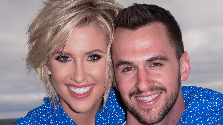 Savannah Chrisley and Nic Kerdiles cuddle on the beach