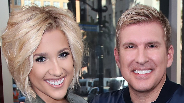 Savannah and Todd Chrisley posing at an event