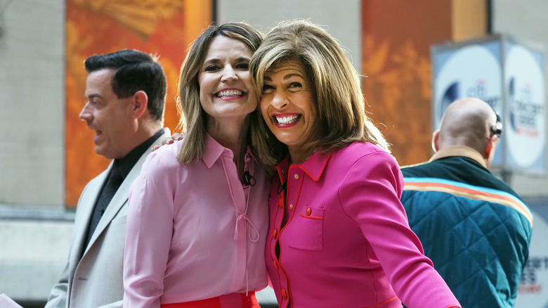 Savannah Guthrie and Hoda Kotb smiling and wearing matching pink ensembles