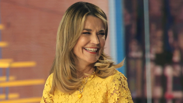 Smiling Savannah Guthrie wearing yellow on set in 2026
