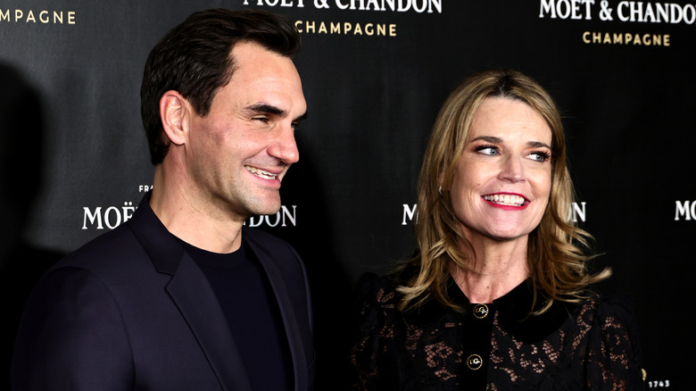 Savannah Guthrie smiling next to Roger Federer in 2022