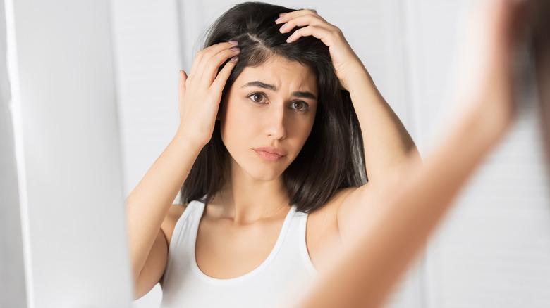 Woman looking at scalp