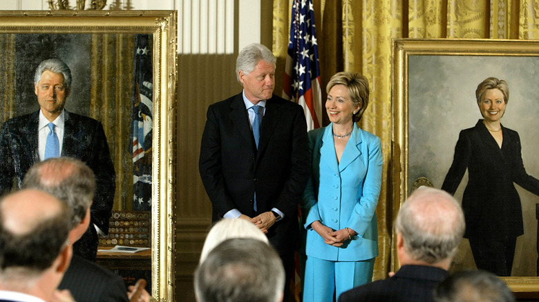 Hillary and Bill Clinton with portraits