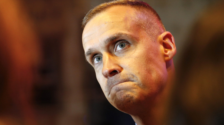 Corey Lewandowski pursing his lips while looking worried