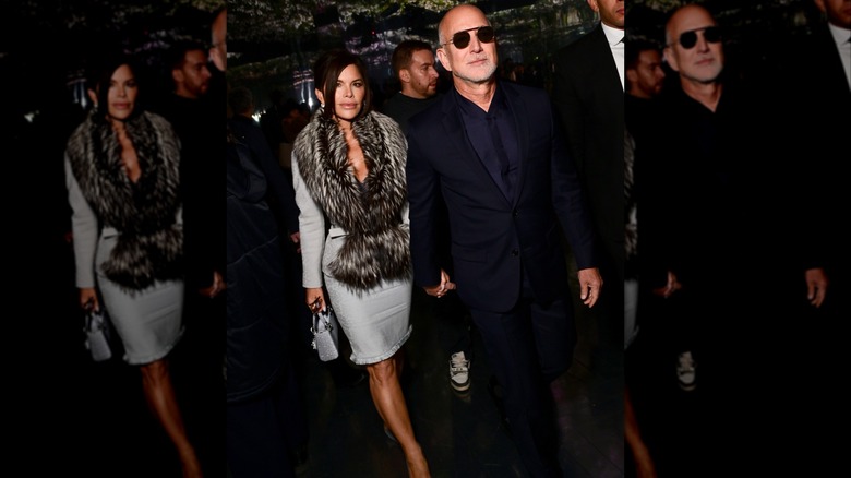 Lauren Sánchez Bezos and Jeff Bezos walking outside holding hands