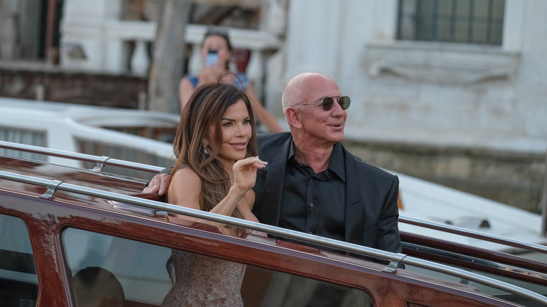 Jeff Bezos and Lauren Sánchez in a gondola in Venice waving to crowds