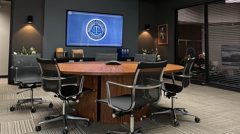 Empty BAU meeting room with chair, table, and screen in Criminal Minds