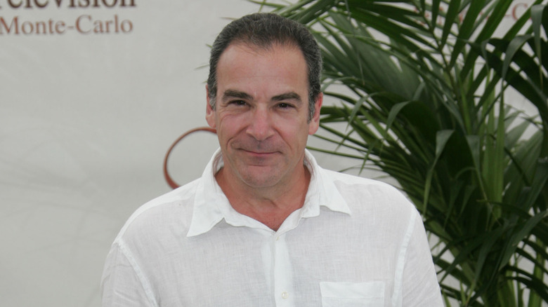 Mandy Patinkin smiling in a white shirt