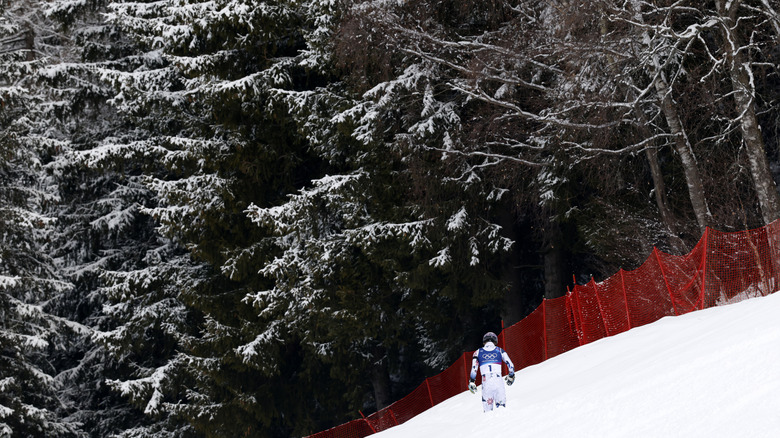 Atle Lie McGrath heading toward the woods at the 2026 Milano Cortino Olympics