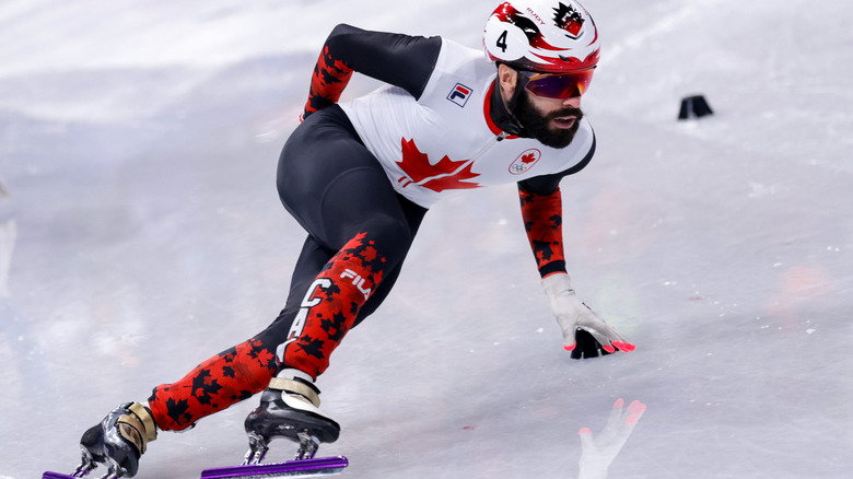 Canadian speed skater Steven Dubois skating on visibly wet ice