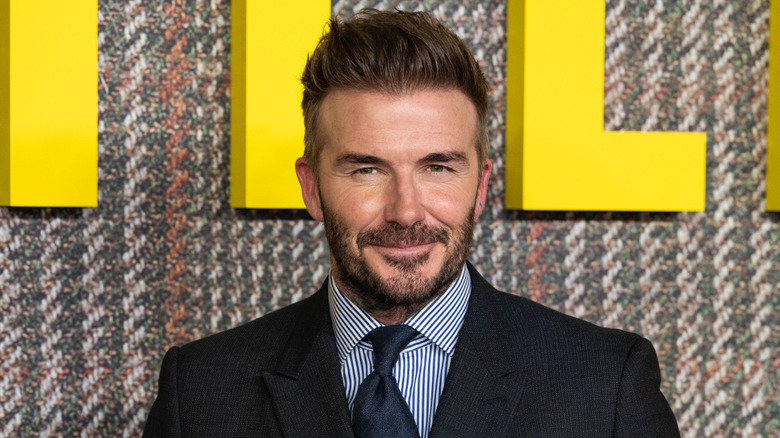 David Beckham smirking at an event