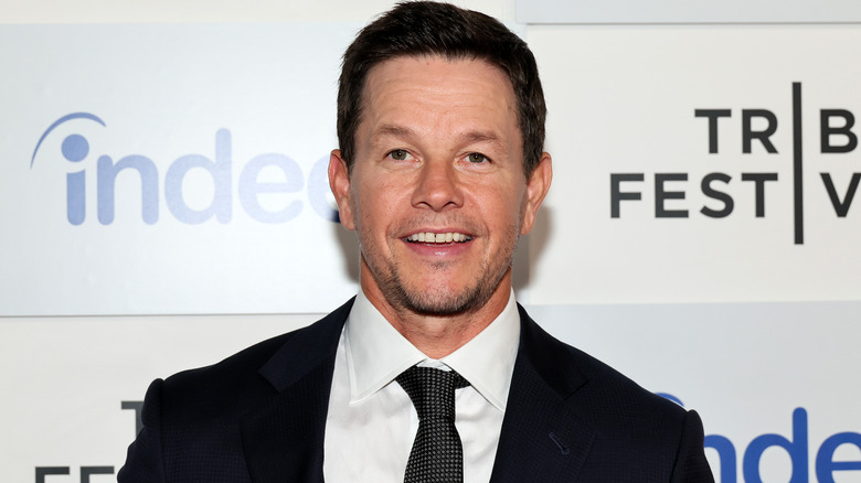 Mark Wahlberg smiling while attending an event