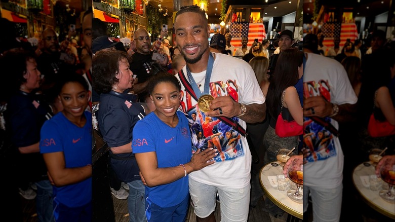 A photo of Simone Biles and husband in Paris celebrating her win