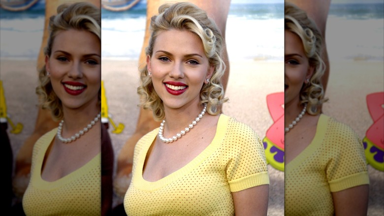 Scarlett Johansson at the premiere of "The SpongeBob SquarePants Movie" with blonde curls and red lipstick