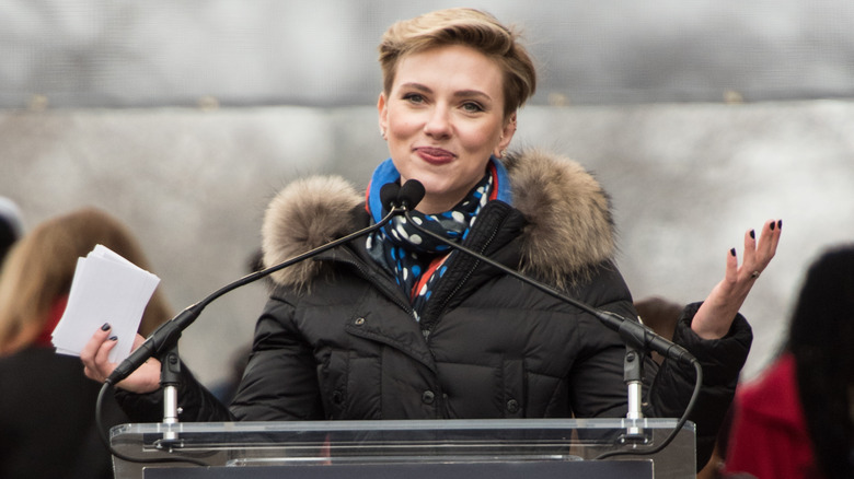 Scarlett Johansson giving a speech at the Women's March in a fluffy parka