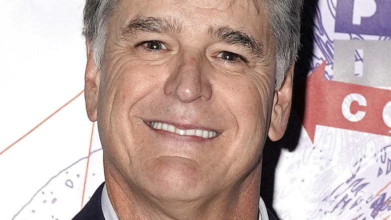 Sean Hannity smiles on the red carpet